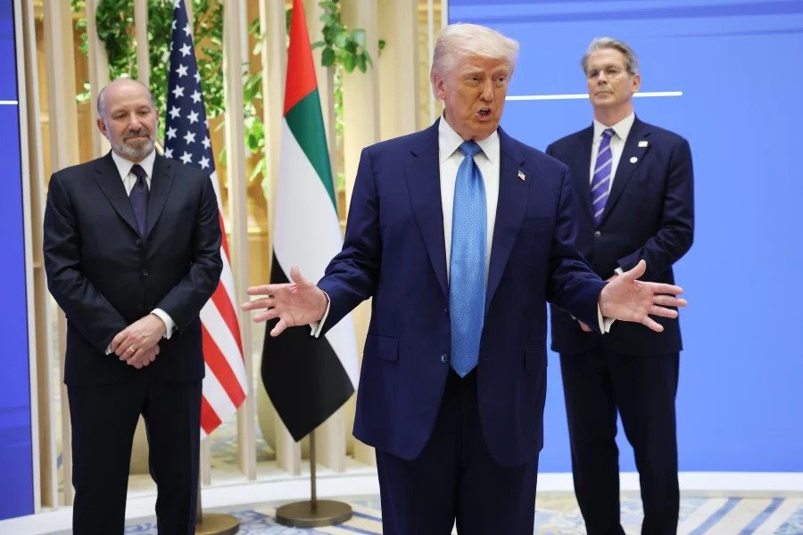 president doanald trump holds up a printed article from "american thinker "